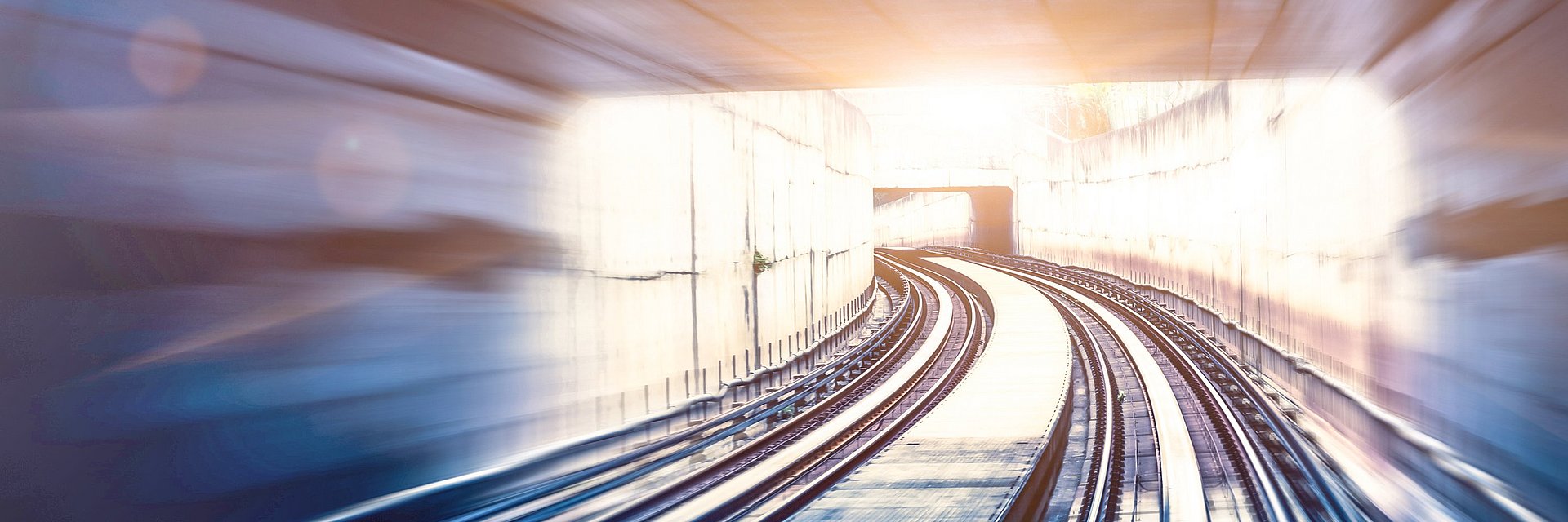 A tunnel with train tracks and some distortion that gives the impression of great speed