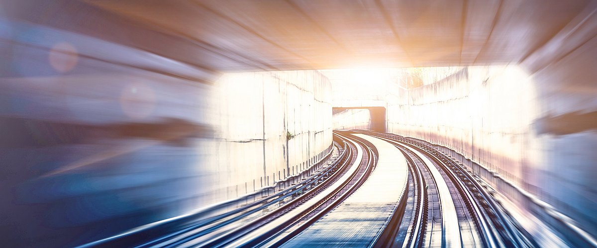 A tunnel with train tracks and some distortion that gives the impression of great speed