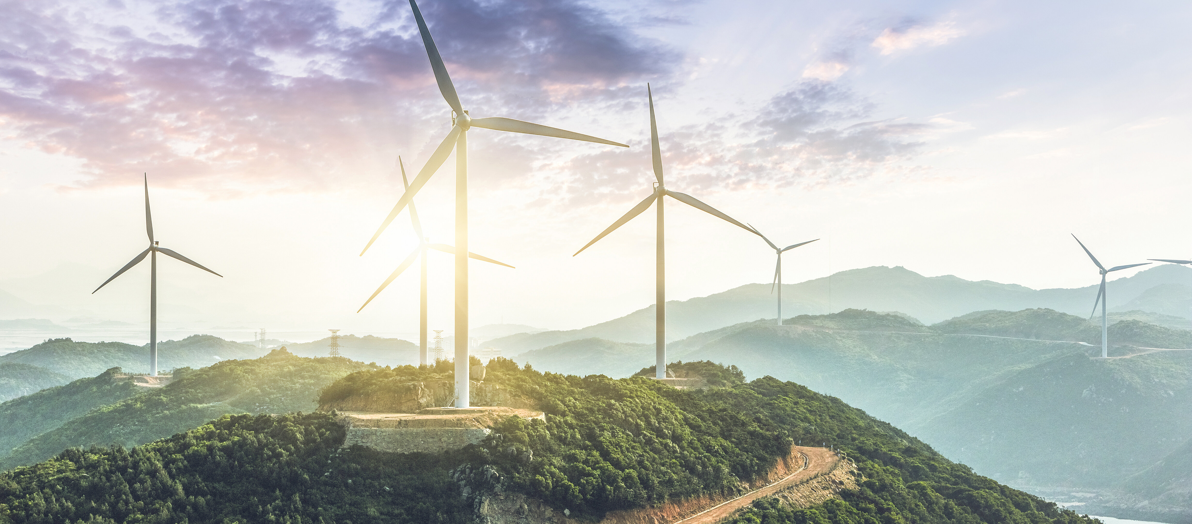 Wind turbines on a hill with light and warmth for green enegry and energy storage development at IBU-tec