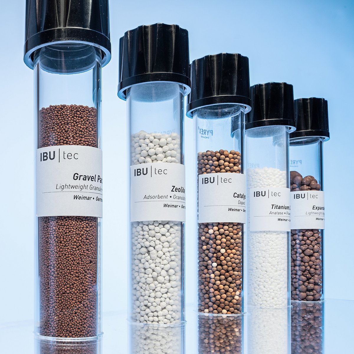 IBU-tec test tube with several material samples showcasing our capability for tolling services for powders and granules