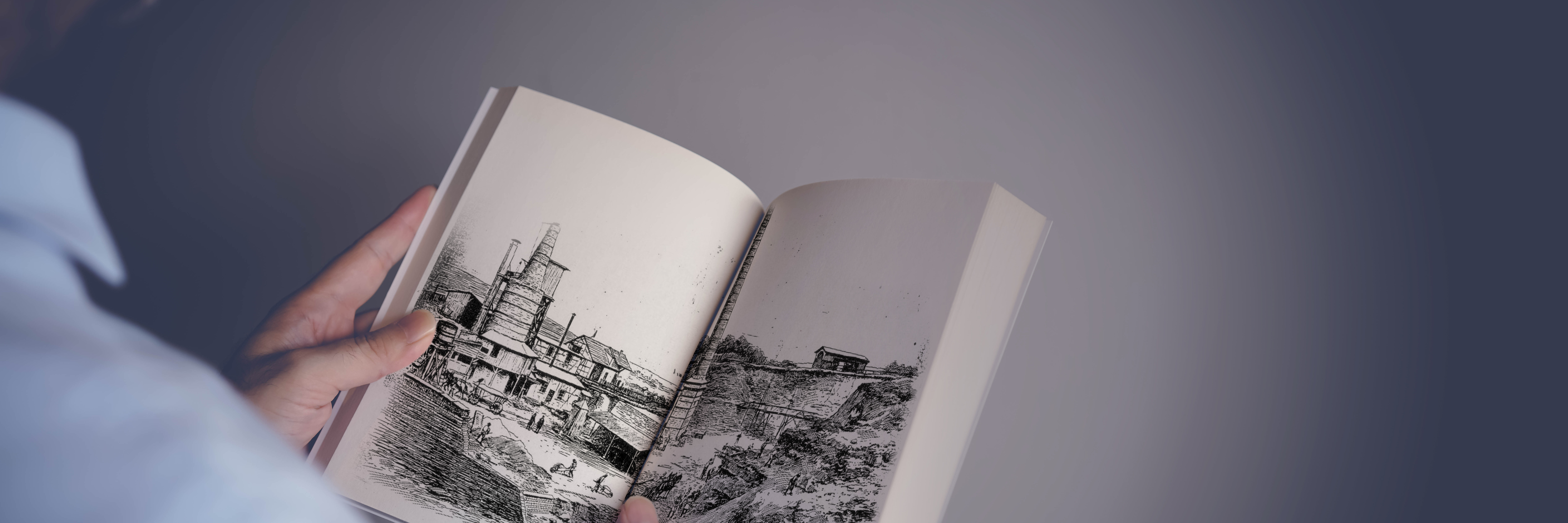 An open book with IBU-tec's company history showing an old picture of the lime plant