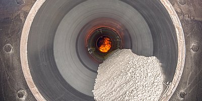 Indirect fired rotary kiln tube with bulk solid material and flame at IBU-tec for scale-up and process trials as well as tolling production with processes like calcination, drying and pyrolysis