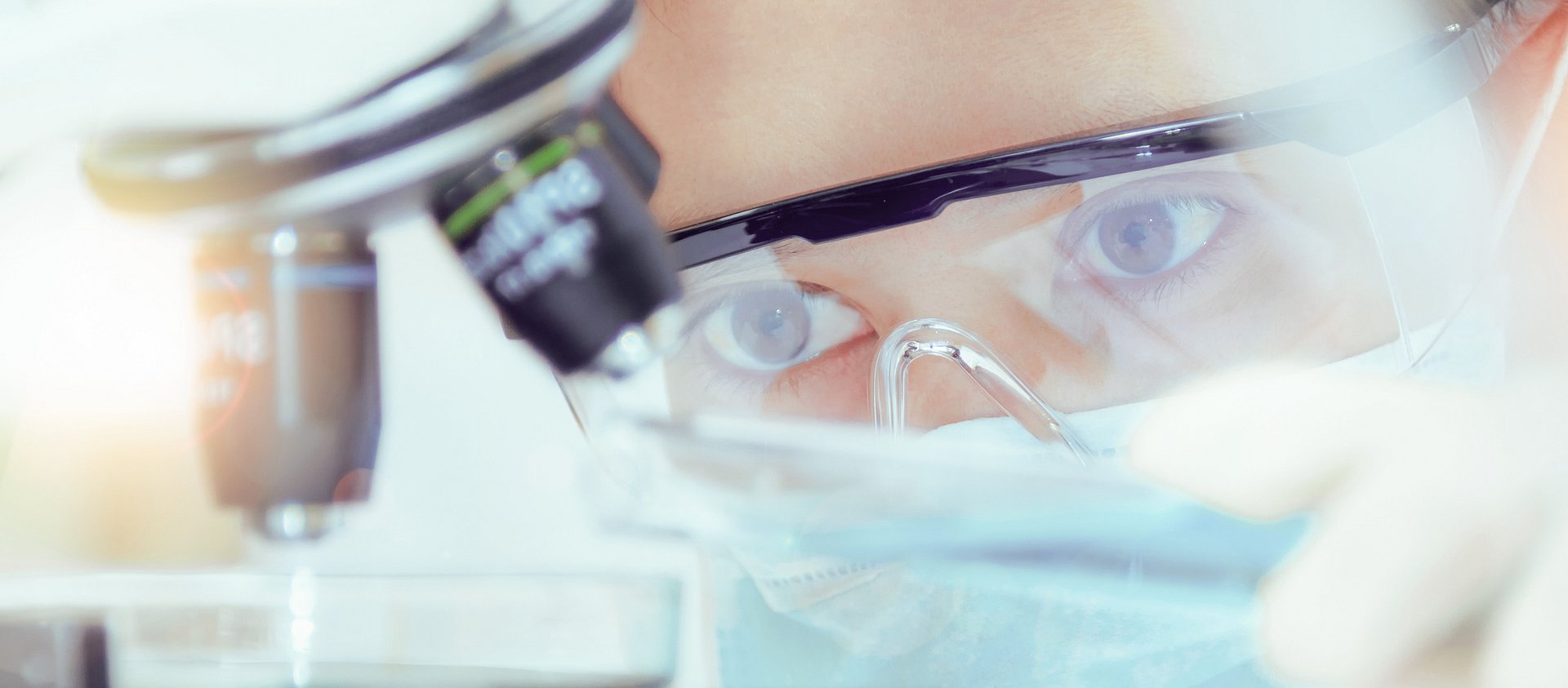 Scientist with microscope in a laboratory on an IBU-tec picture