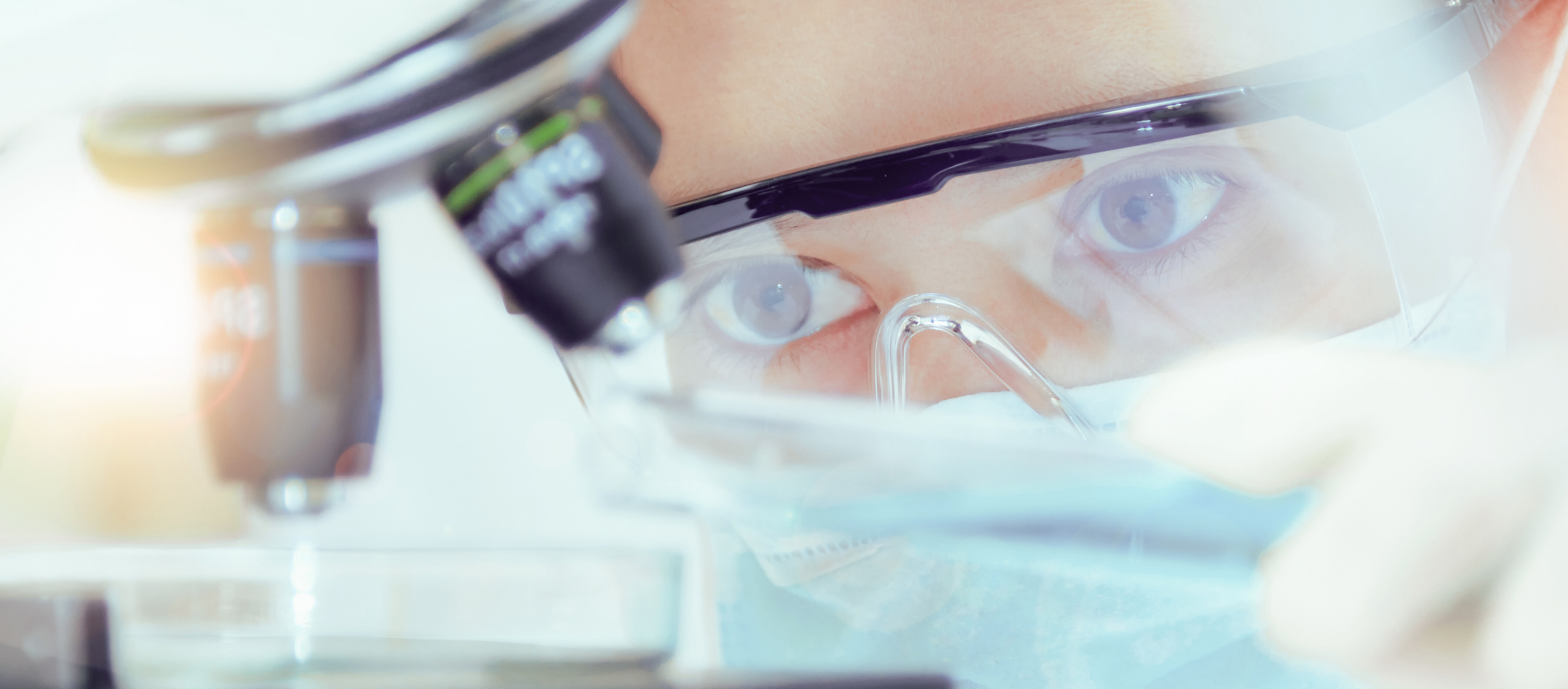 Scientist with microscope in a laboratory on an IBU-tec picture