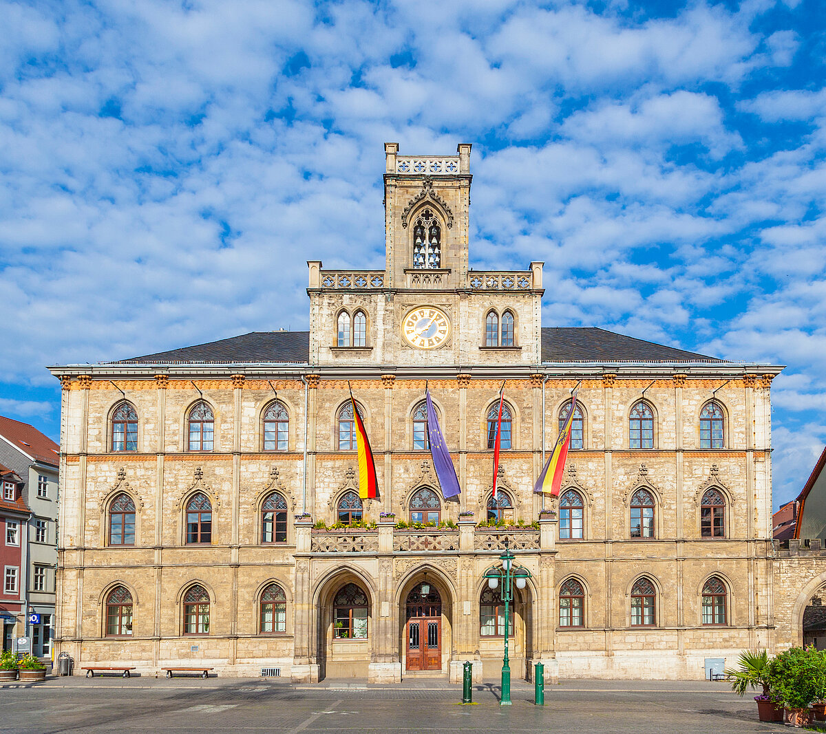 Weimar town hall with market place and flags, classical Weimar with beautiful architecture Weimar town hall with market place and flags, classical Weimar with beautiful architecture