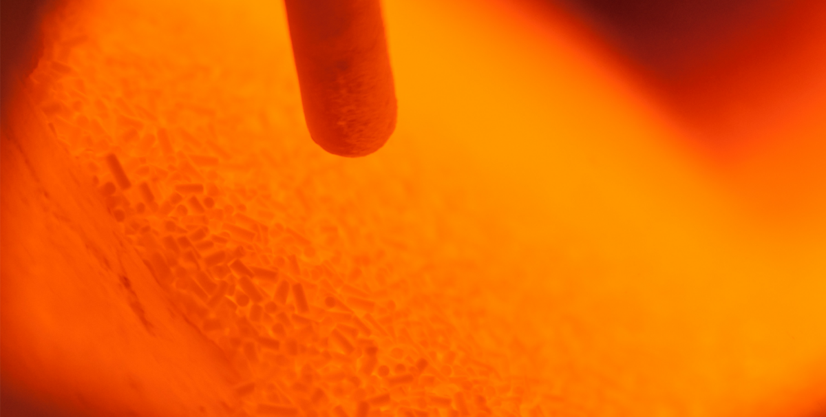 Glowing chemical material in a rotary kiln with a thermo couple visible. Its glowing red in a rolling motion, looking quite impressive.